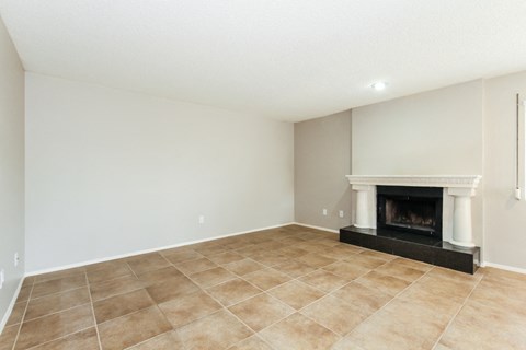 the living room has a fireplace and tile flooring