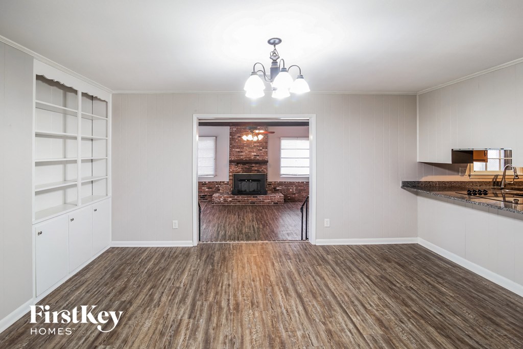 A room with wooden floors and a chandelier.