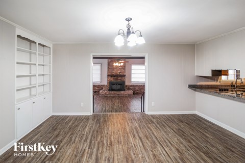 A room with wooden floors and a chandelier.