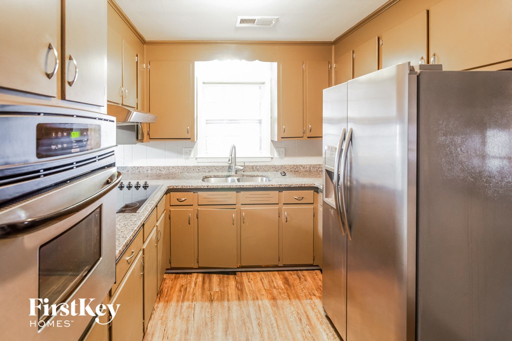 A kitchen with wooden cabinets and stainless steel appliances.