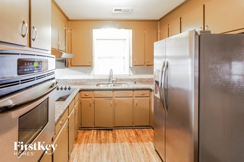 A kitchen with wooden cabinets and stainless steel appliances.