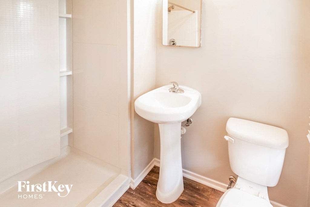 A white sink and toilet in a small bathroom.