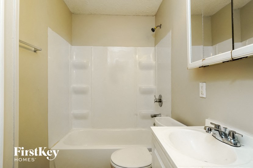 a bathroom with a sink toilet and a shower