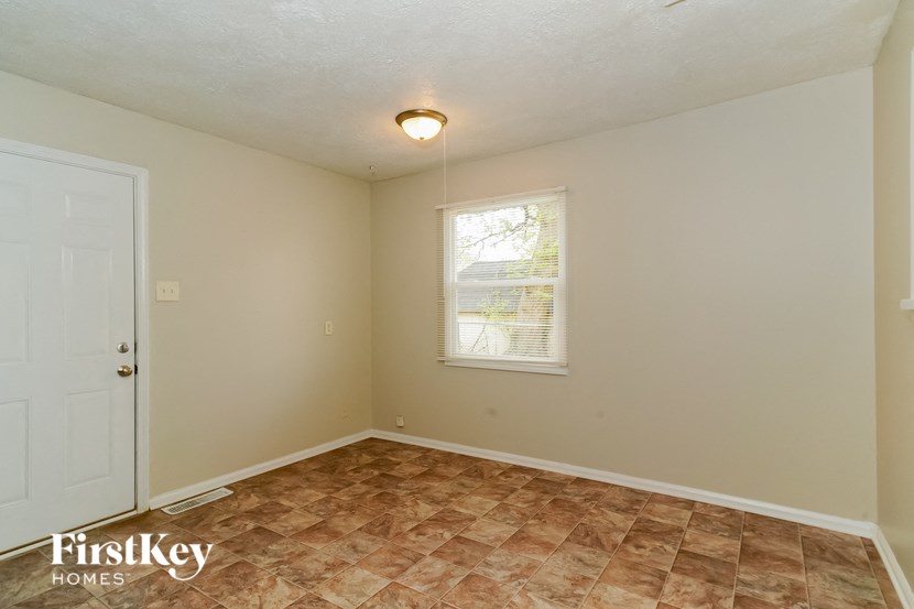 the living room of an empty house with a window