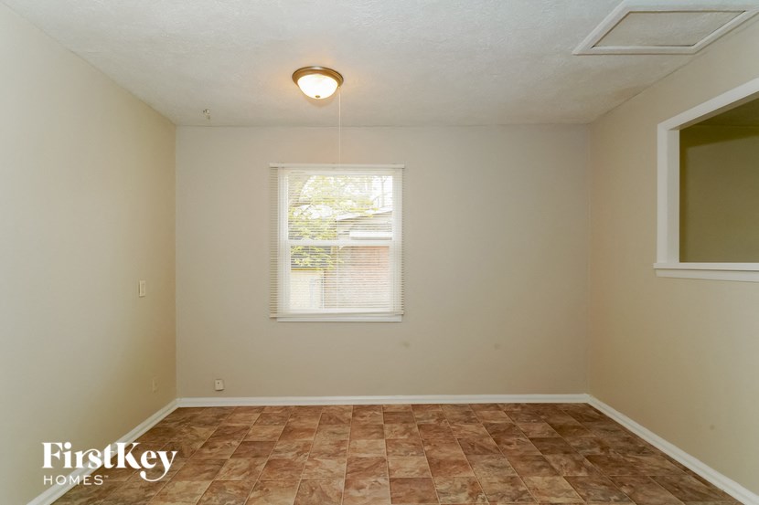 the living room of an empty house with a window