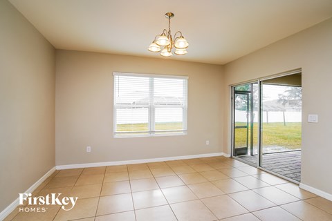 an empty dining room with a sliding glass door to the yard