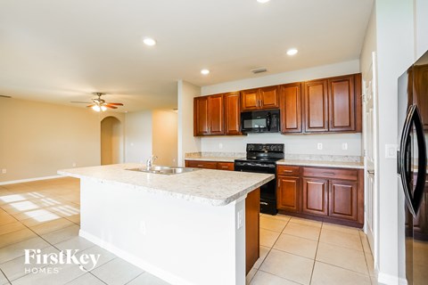 a kitchen with wooden cabinets and a white counter top