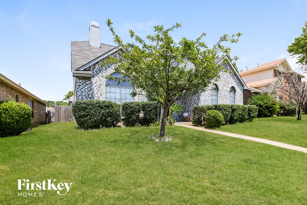 A house with a tree in front of it.