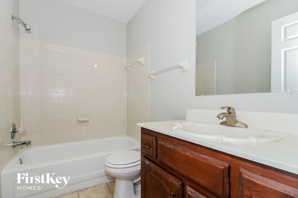 a bathroom with a sink and a toilet and a bath tub