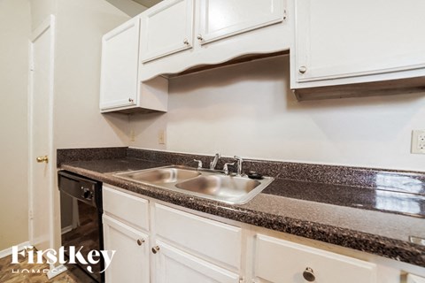 A kitchen with a sink and cabinets.
