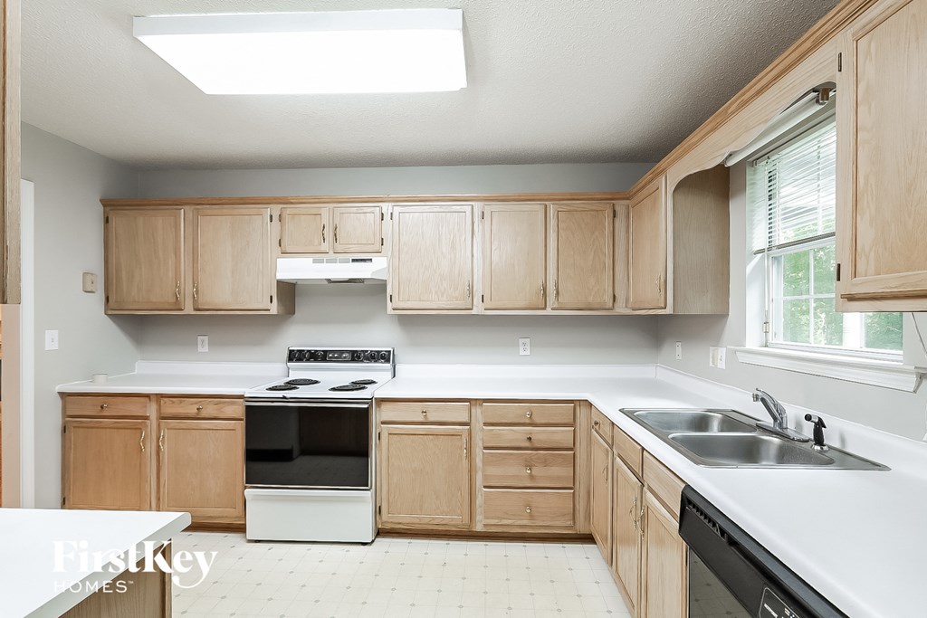 a kitchen with wooden cabinets and white counter tops