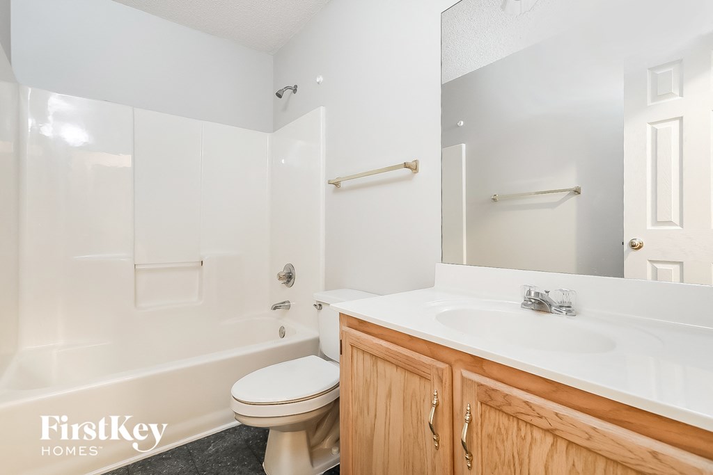 a bathroom with a sink toilet and a shower