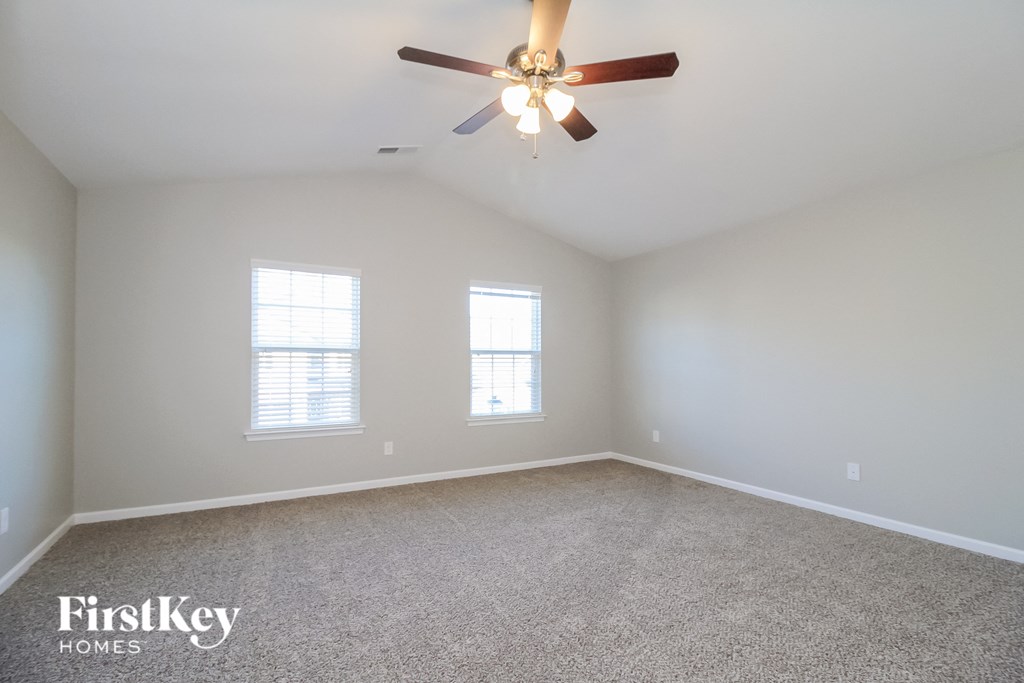 the master bedroom is spacious and has a ceiling fan