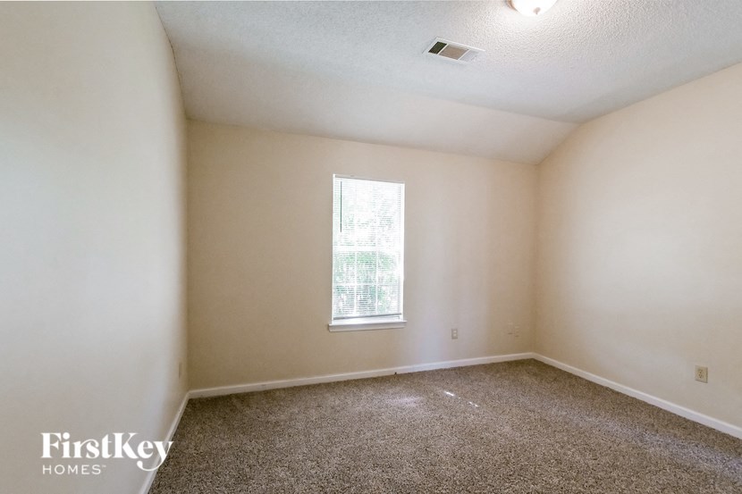 a room with carpet and a window in it