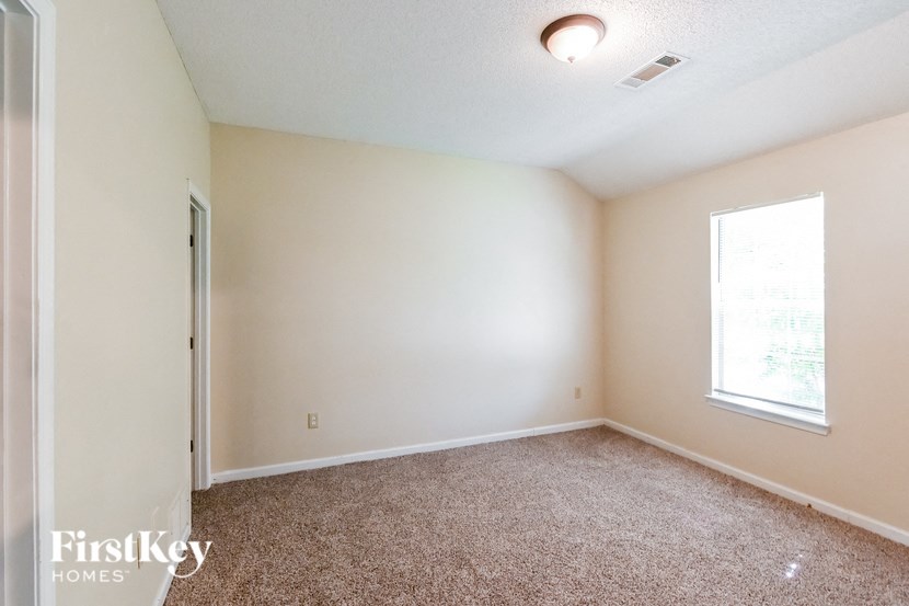 a room with a carpeted floor and a window