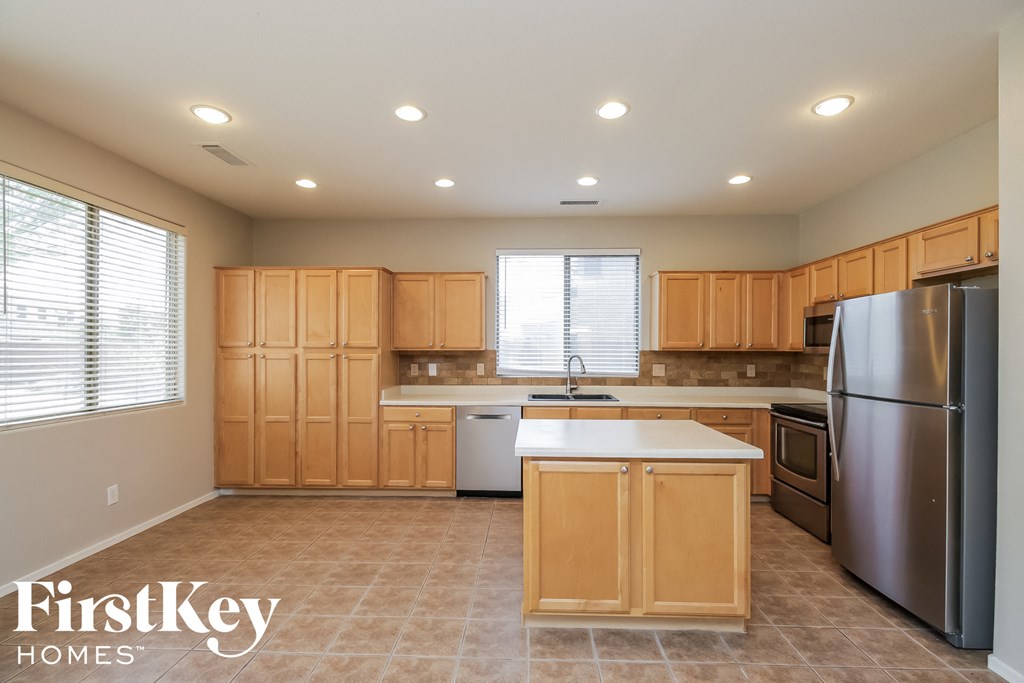 a kitchen with wooden cabinets and stainless steel appliances