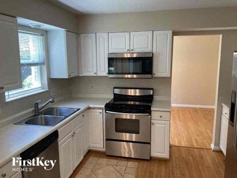 A kitchen with white cabinets and stainless steel appliances.