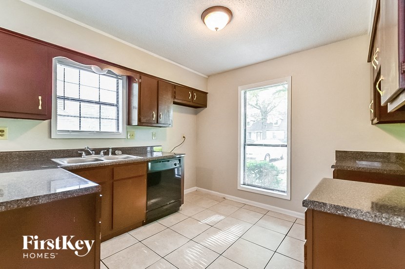 an empty kitchen with a sink and a window