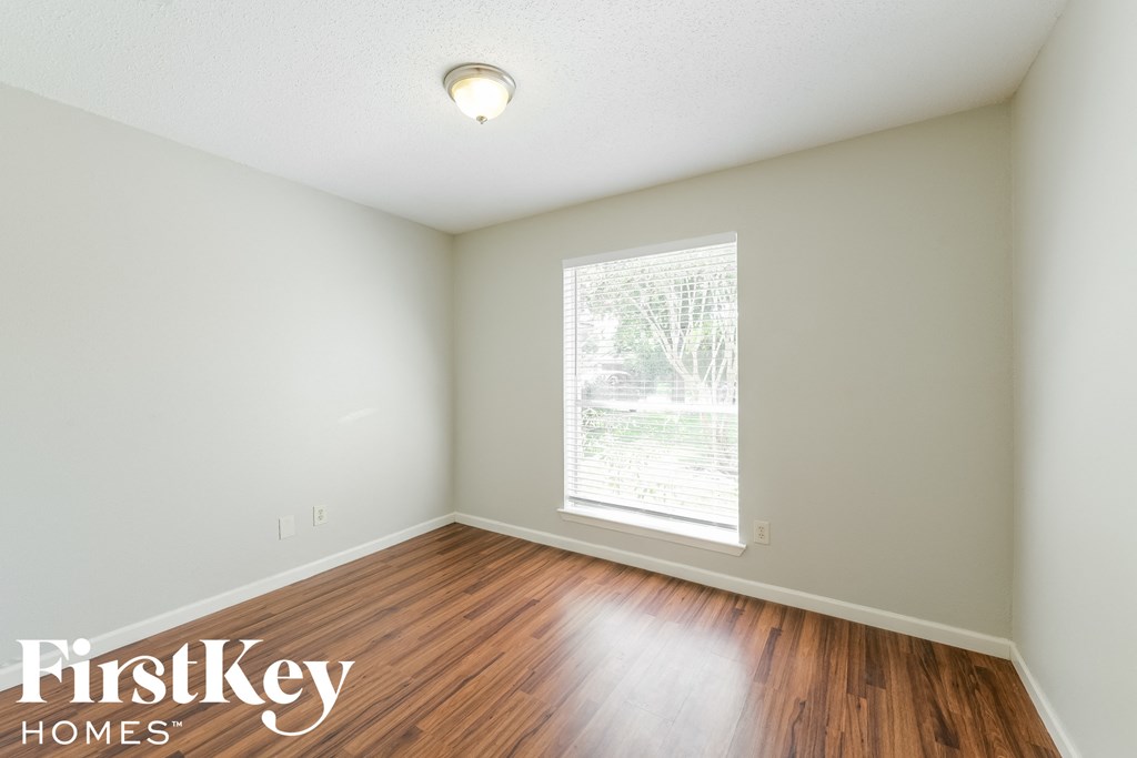 A room with a FirstKey Homes logo on the bottom left corner.