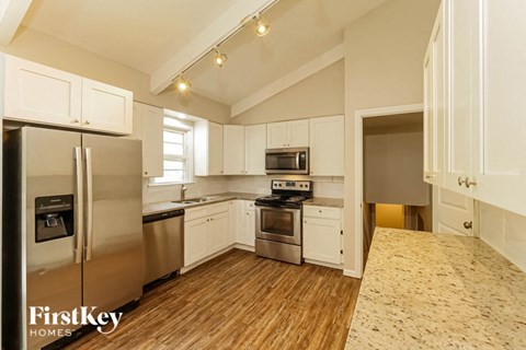 a kitchen with stainless steel appliances and white cabinets