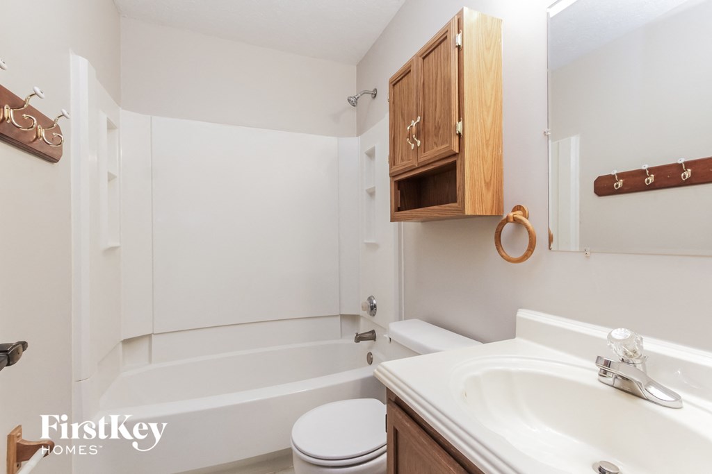 a bathroom with a sink and a toilet and a bath tub