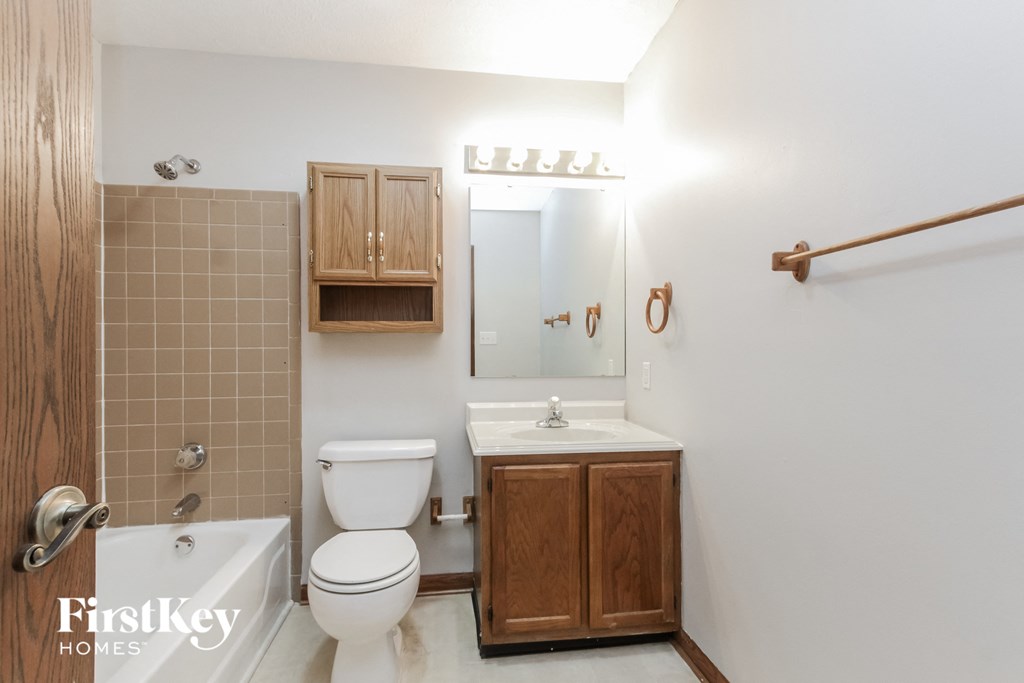 a bathroom with a toilet and a sink and a mirror