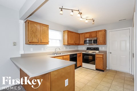 a kitchen with wooden cabinets and a white counter top