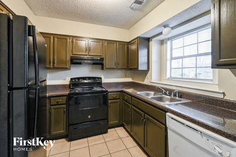 a kitchen with black appliances and brown cabinets