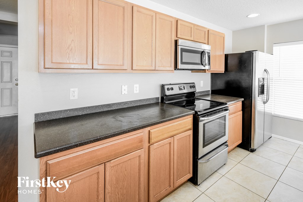 a kitchen with stainless steel appliances and wooden cabinets