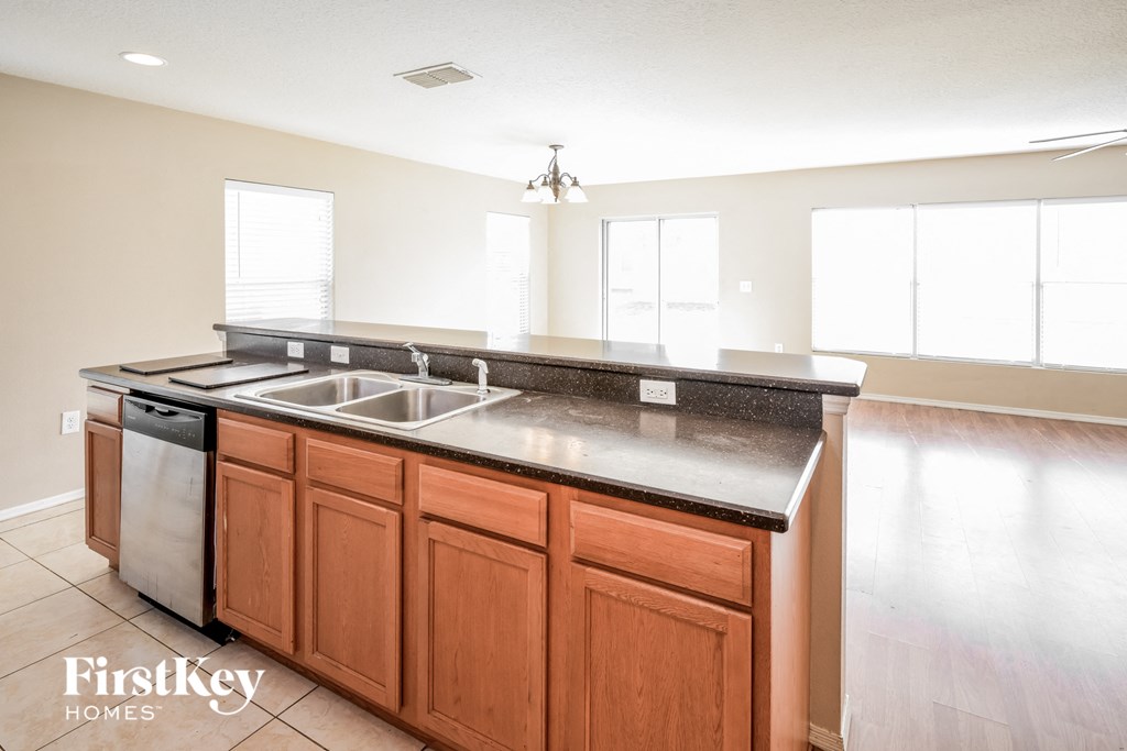 a kitchen with wooden cabinets and a stainless steel counter top