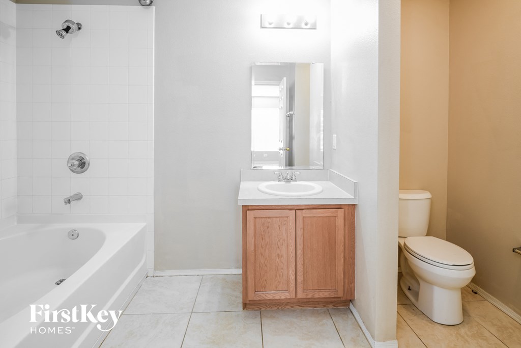 a bathroom with a sink toilet and a bath tub