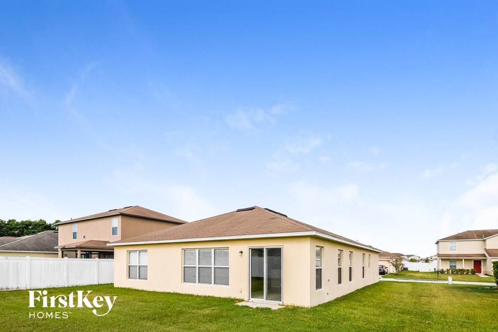 a house with green grass and a blue sky