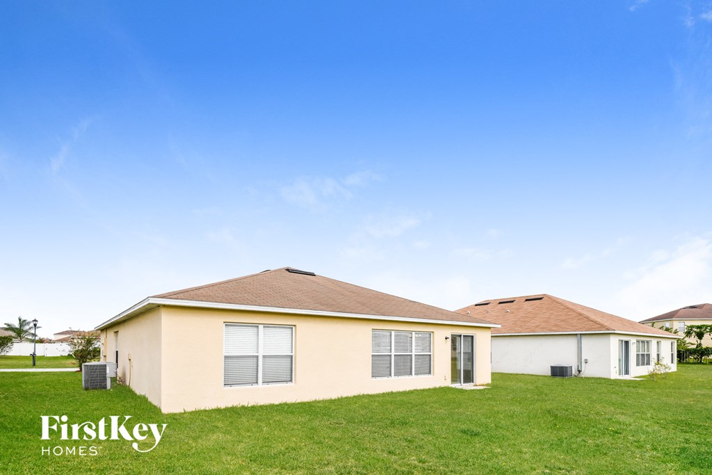 a house with a lawn and a blue sky