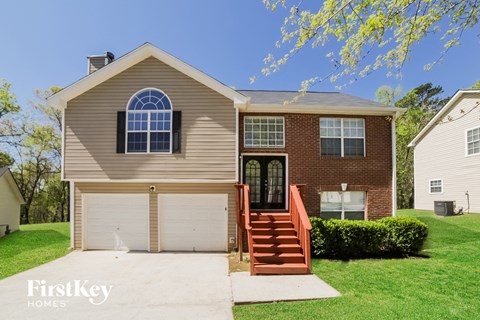 a brown house with a white garage door