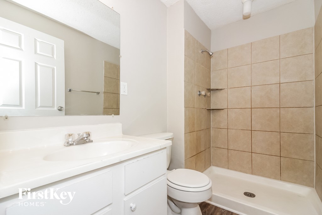 a bathroom with a sink toilet and a shower