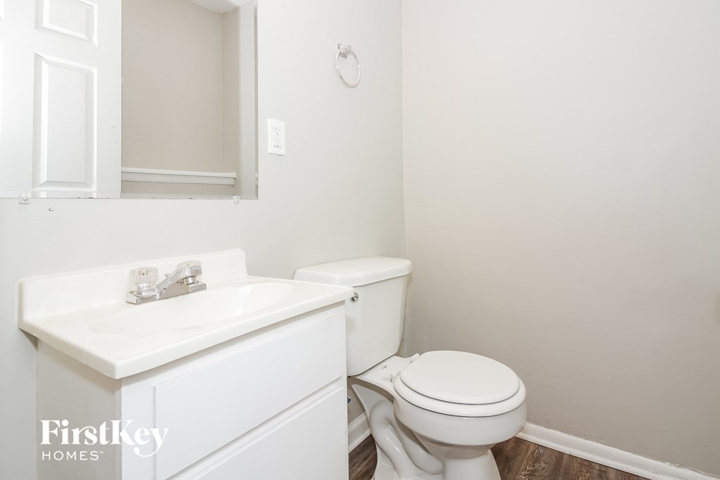 a bathroom with a toilet and a sink and a mirror