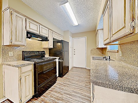 a kitchen with a stove and a refrigerator