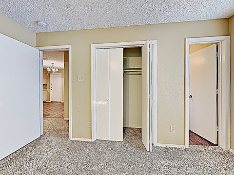 the living room of an apartment with doors to the bedroom and the hallway