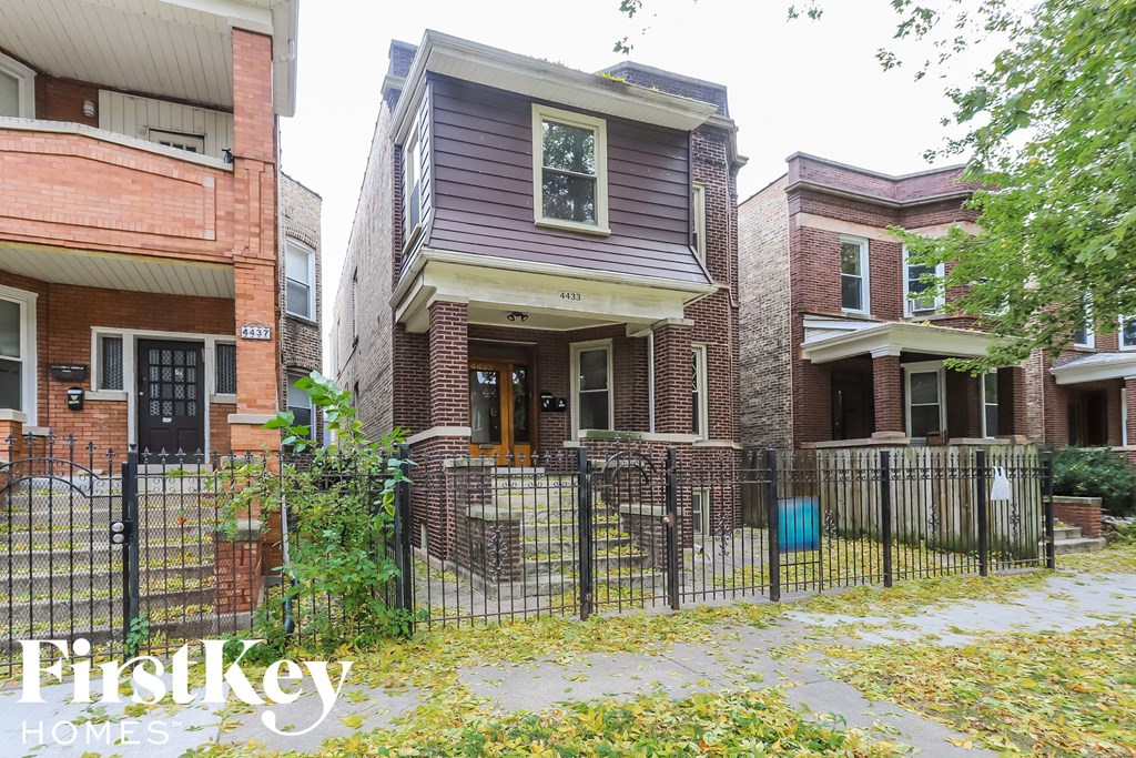 a small house with a fence in front of it