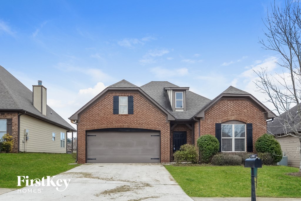 front view of a brick house with a garage door