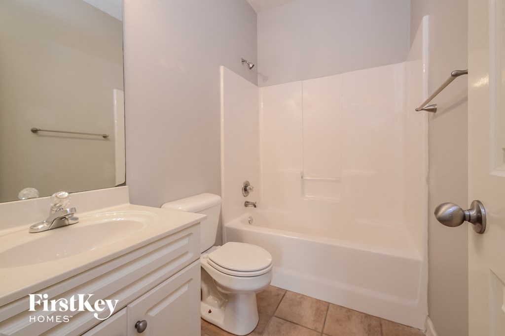 a bathroom with a sink toilet and a tub