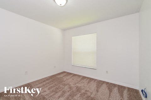 a living room with carpet and a window
