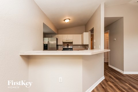 A kitchen area with a counter and cabinets.