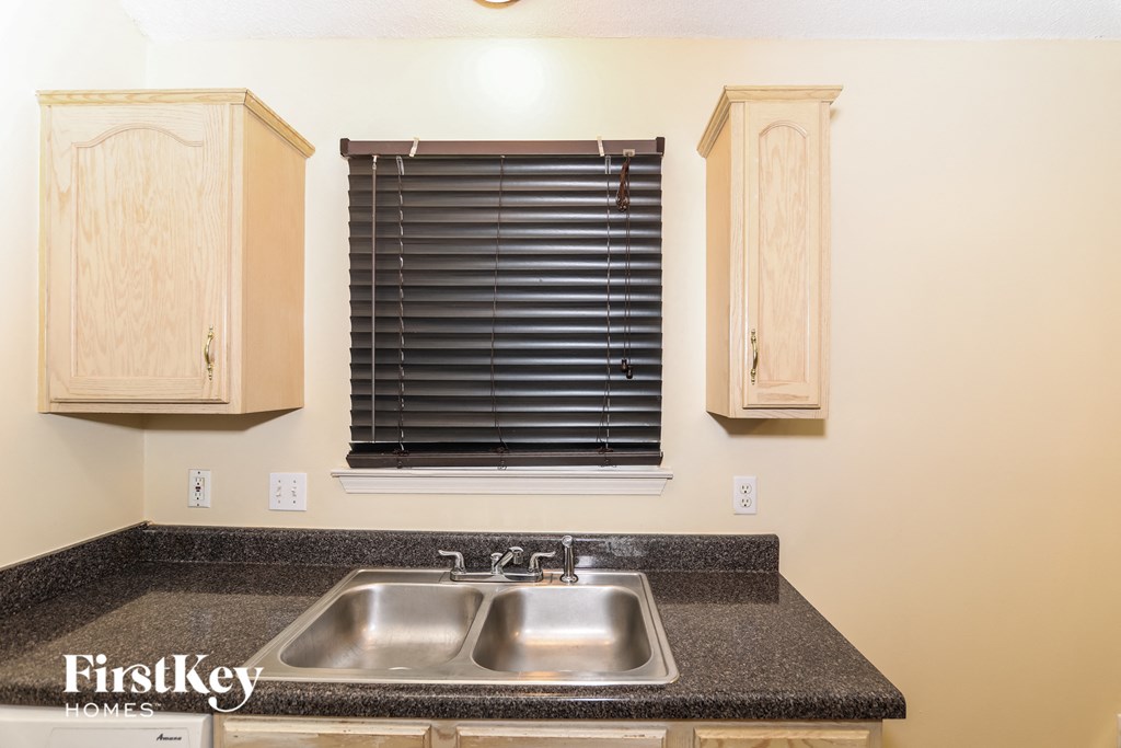 A kitchen with a sink and cabinets.