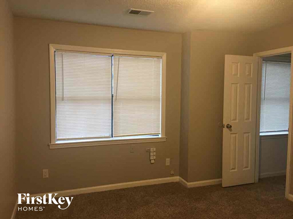 A room with a window and a door.