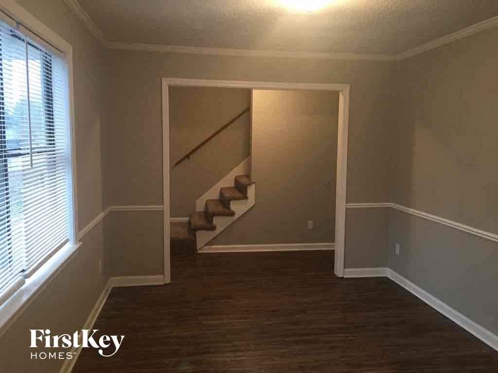 A room with a staircase leading to the upper floor.