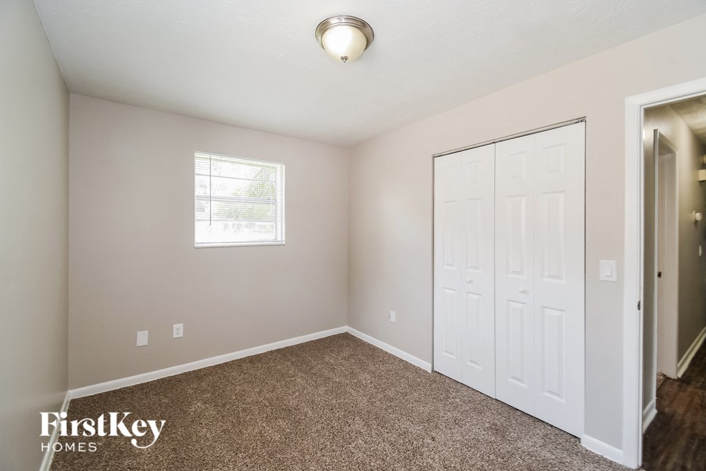 a bedroom with a closet and a white door