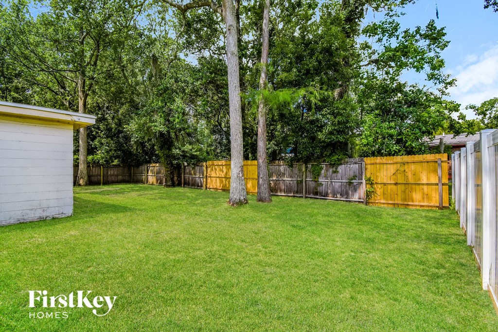a fisheye view of a backyard with a fence and trees