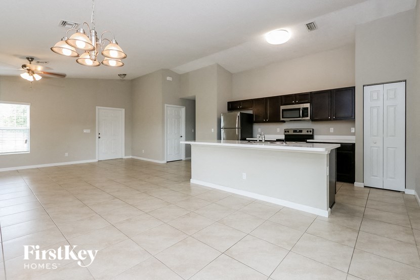 A spacious kitchen with a white island and modern appliances.