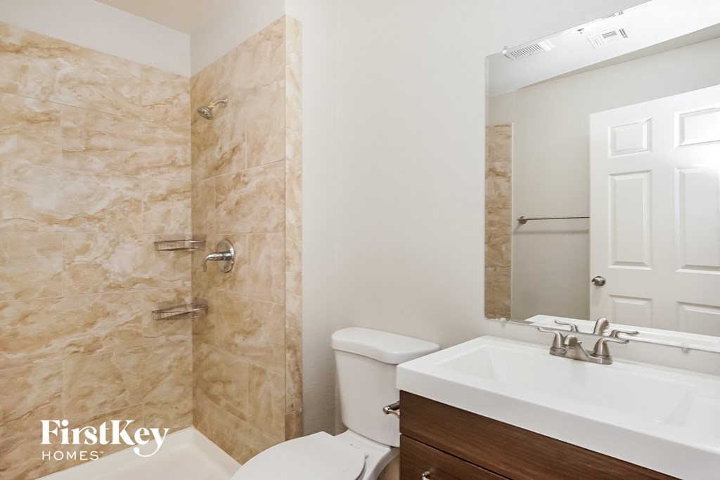 a bathroom with a sink toilet and a shower